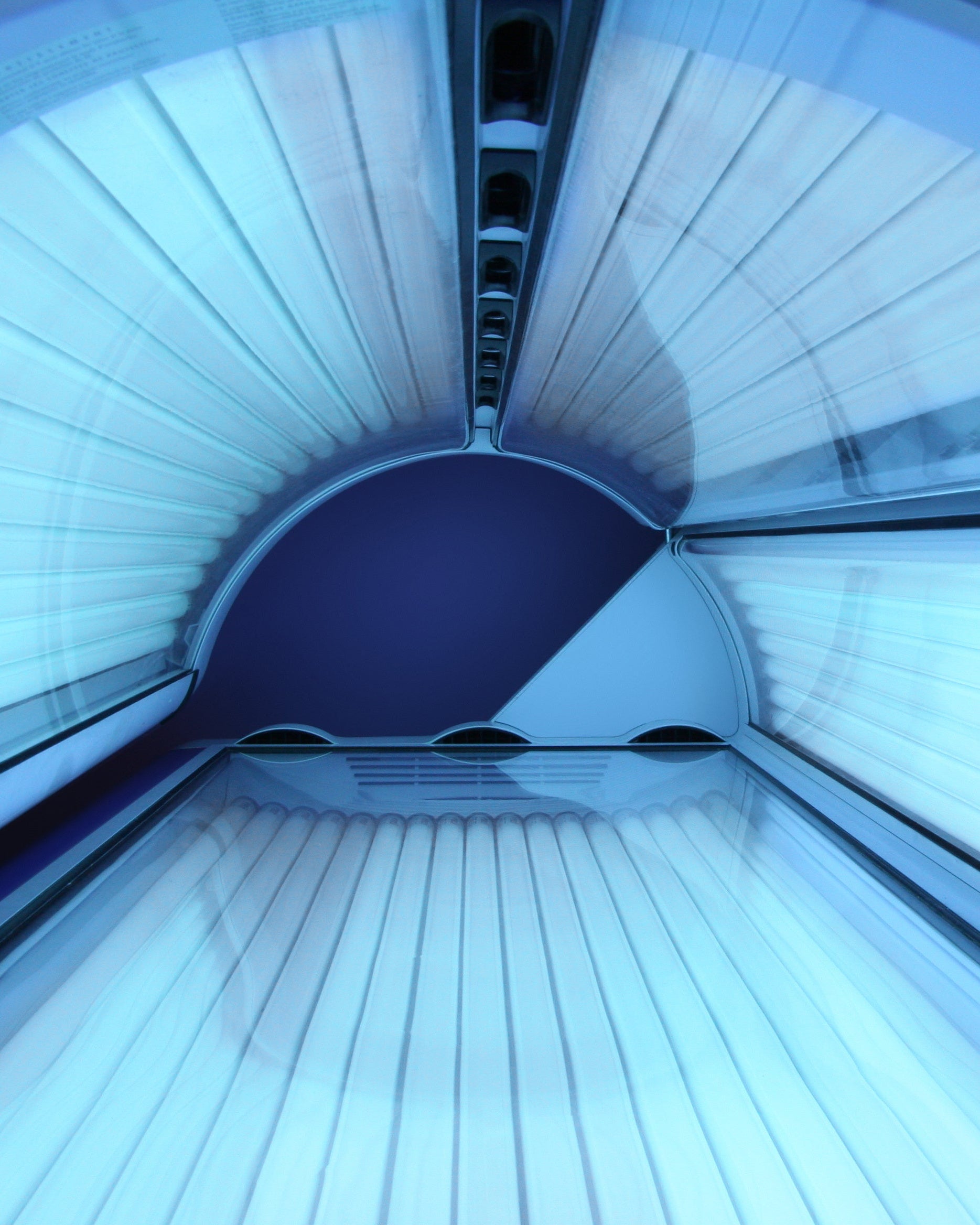 Interior of a tanning booth with blue lighting